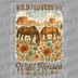Illustration of two horses grazing in a field of wildflowers with a desert canyon background and text Wild Flowers and Wild Horses DTF transfer ready to press.